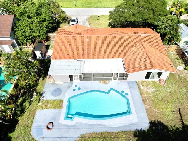 an aerial view of a house with a swimming pool