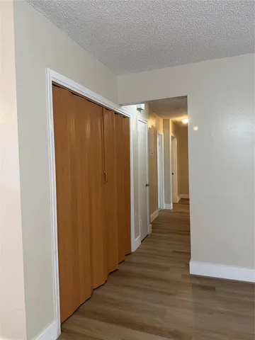 a view of a room with wooden floor