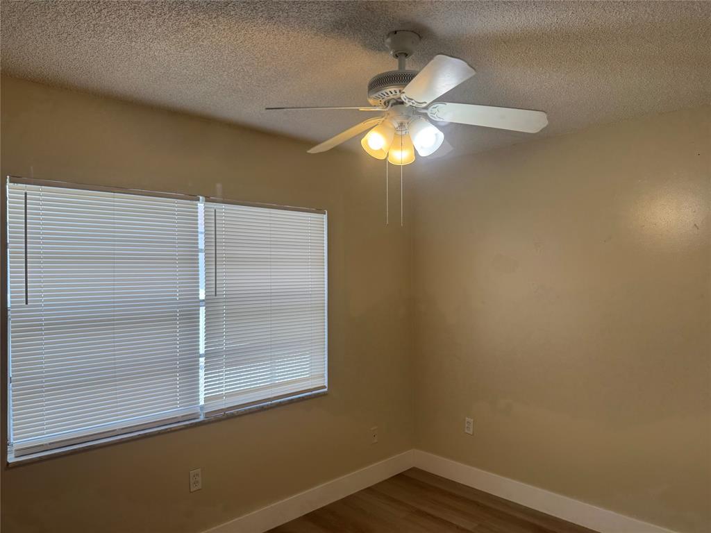 2156 Northwest 66th Street Miami, FL 33147 - Photo 15 of 29 en empty room with a window and chandelier fan