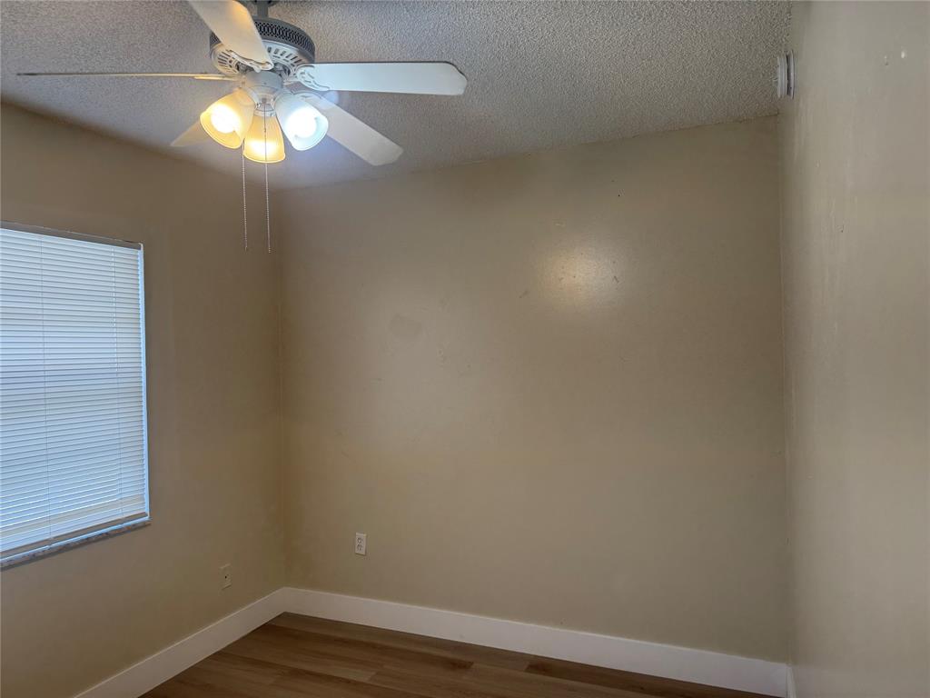 2156 Northwest 66th Street Miami, FL 33147 - Photo 16 of 29 en empty room with wooden floor and fan