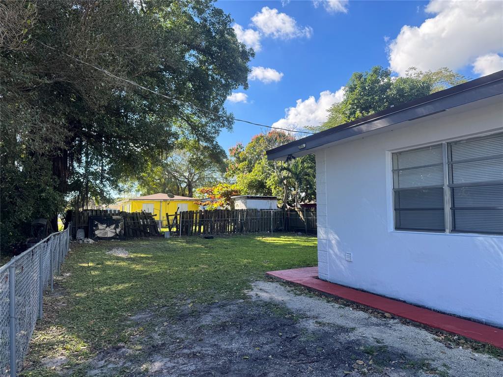 2156 Northwest 66th Street Miami, FL 33147 - Photo 4 of 29 a view of a house with a yard porch and sitting area