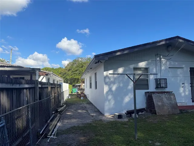 a view of a small house with a yard