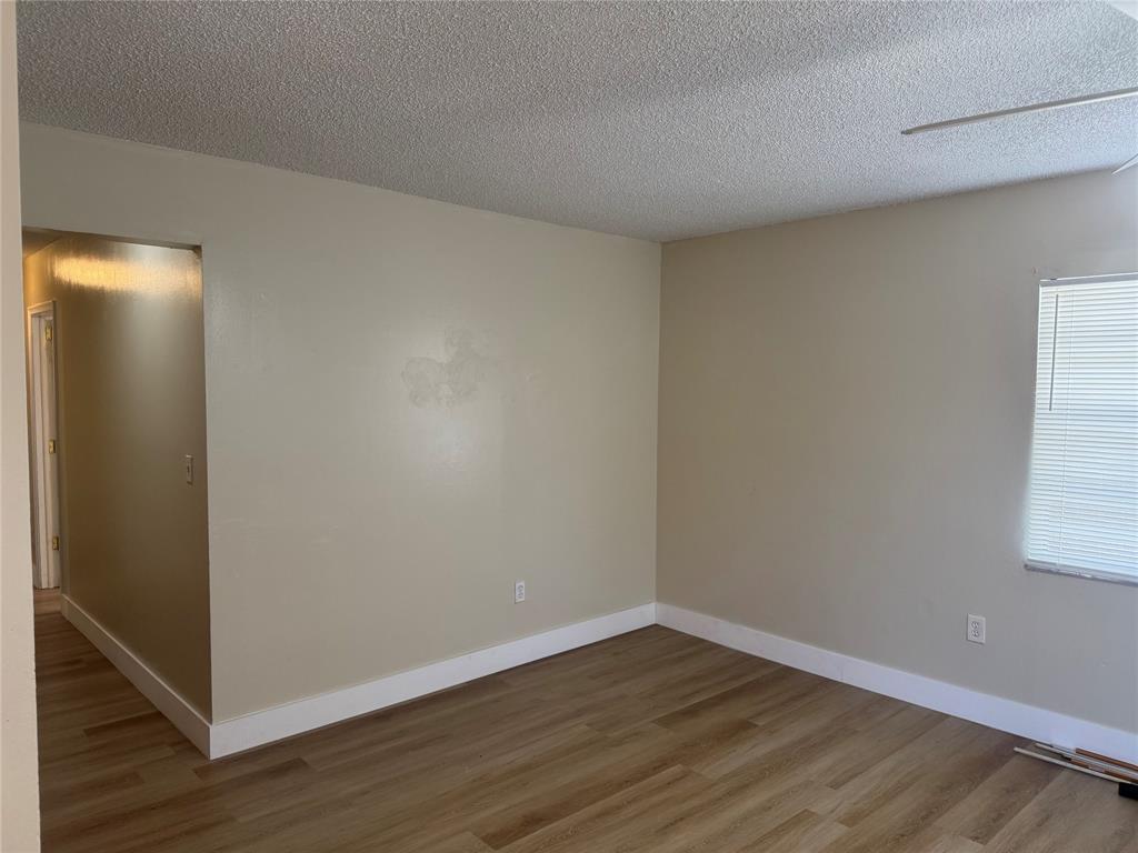 2156 Northwest 66th Street Miami, FL 33147 - Photo 10 of 29 a view of an empty room with wooden floor and a window