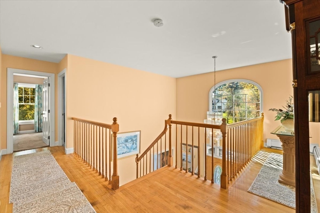 84 Juniper Ridge Road Westwood, MA 02090 - Photo 17 of 28 a view of a hallway with wooden floor and windows