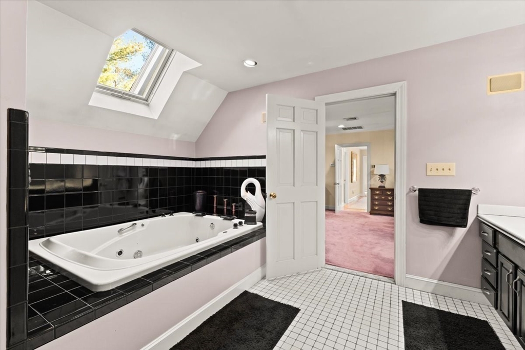 84 Juniper Ridge Road Westwood, MA 02090 - Photo 20 of 28 a bathroom with a sink a bathtub and a mirror