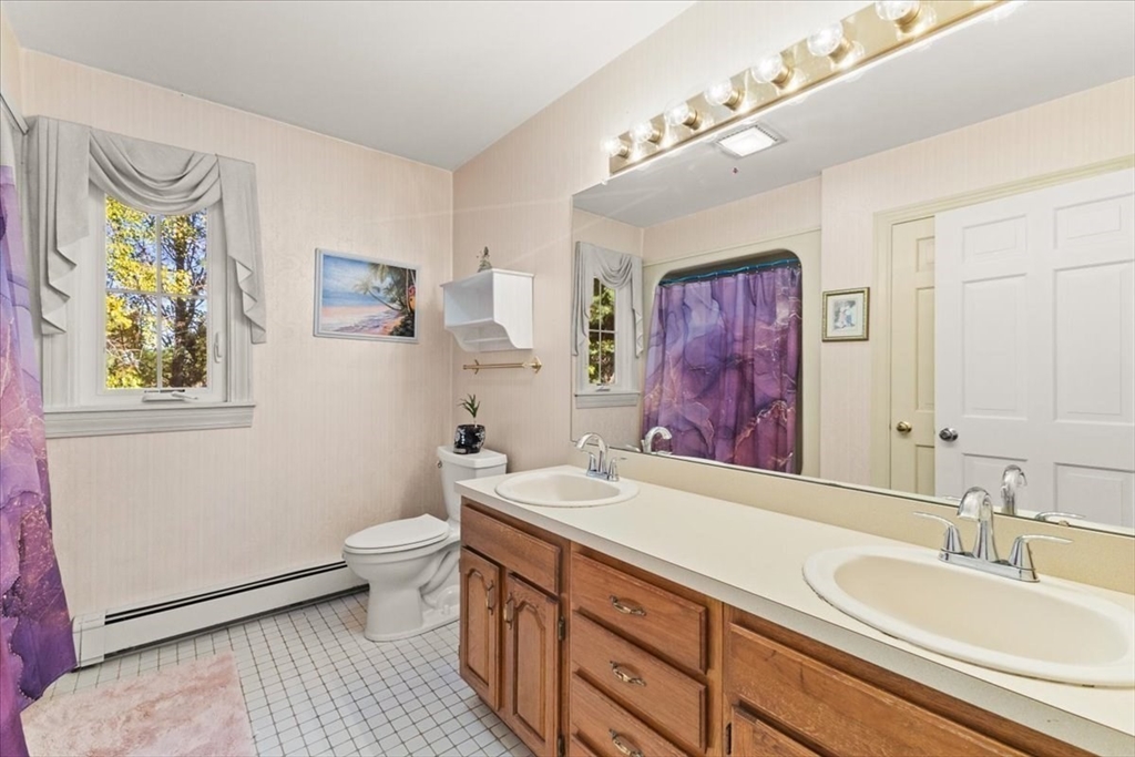 84 Juniper Ridge Road Westwood, MA 02090 - Photo 23 of 28 a spacious bathroom with a sink a mirror a toilet and a shower