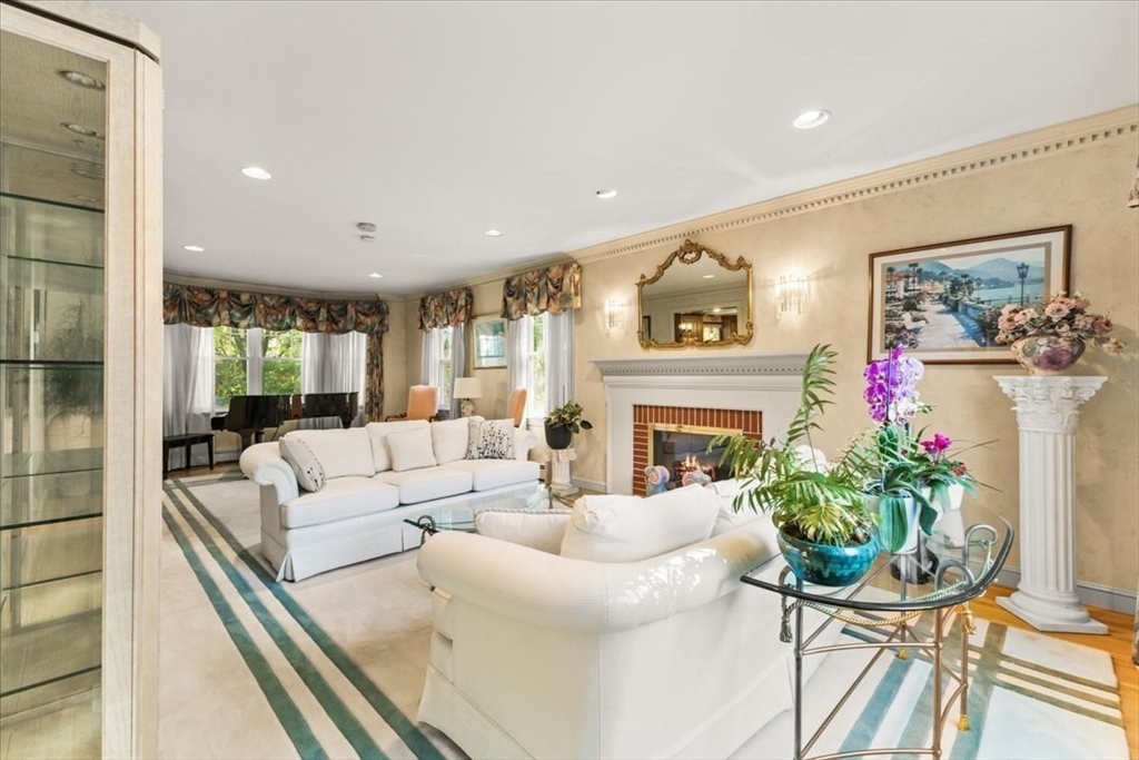 84 Juniper Ridge Road Westwood, MA 02090 - Photo 8 of 28 a living room with furniture a fireplace and a potted plant