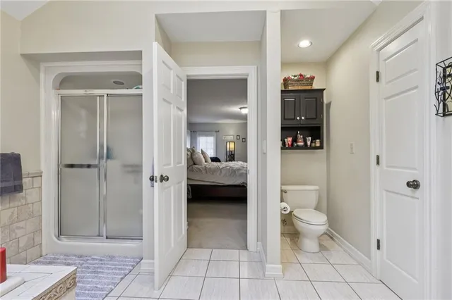 a spacious bathroom with a tub sink and mirror
