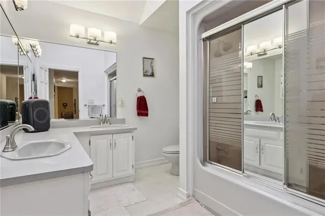 a bathroom with a glass door shower and a bathtub