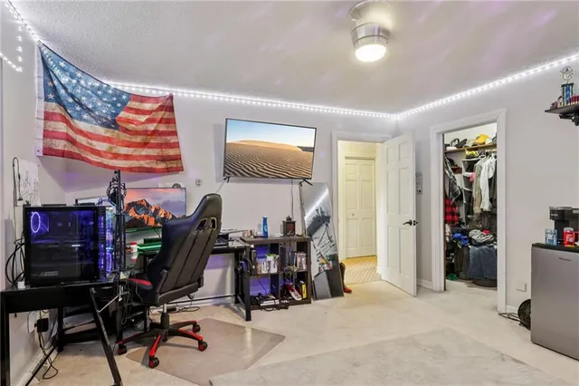 a bedroom with furniture and a book shelf