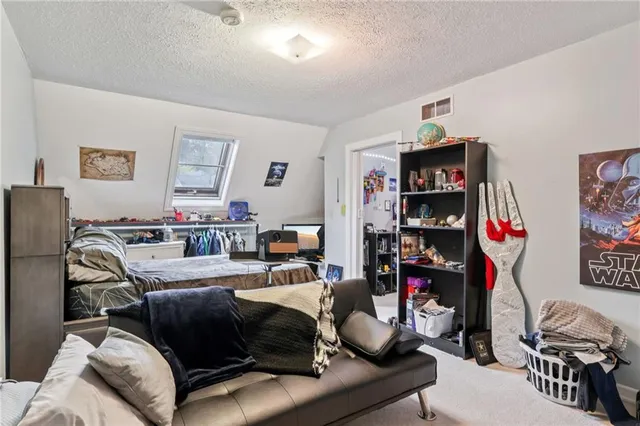 a large kitchen with stainless steel appliances a sink and a refrigerator