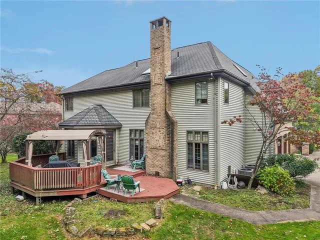 a front view of a house with a yard and trees