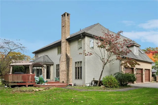 a view of a house with a yard and sitting area