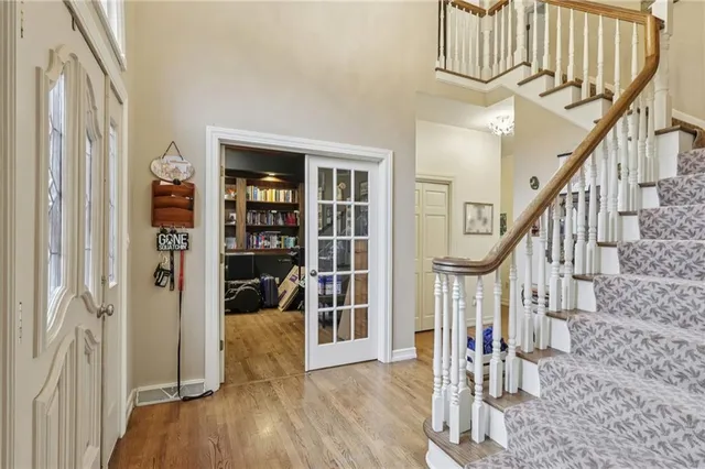a view of entryway and hall with wooden floor