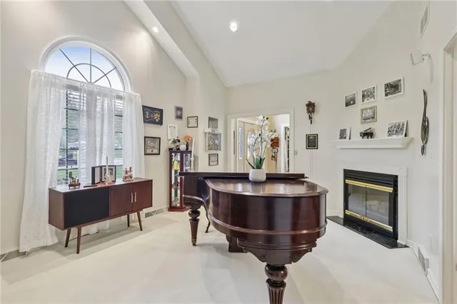 a living room with furniture a fireplace and a large window
