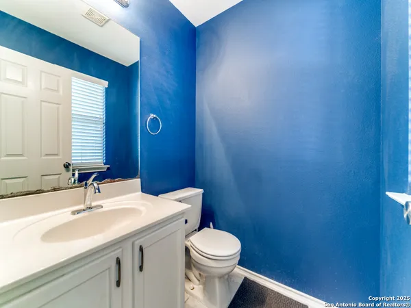 a bathroom with a sink a toilet and mirror