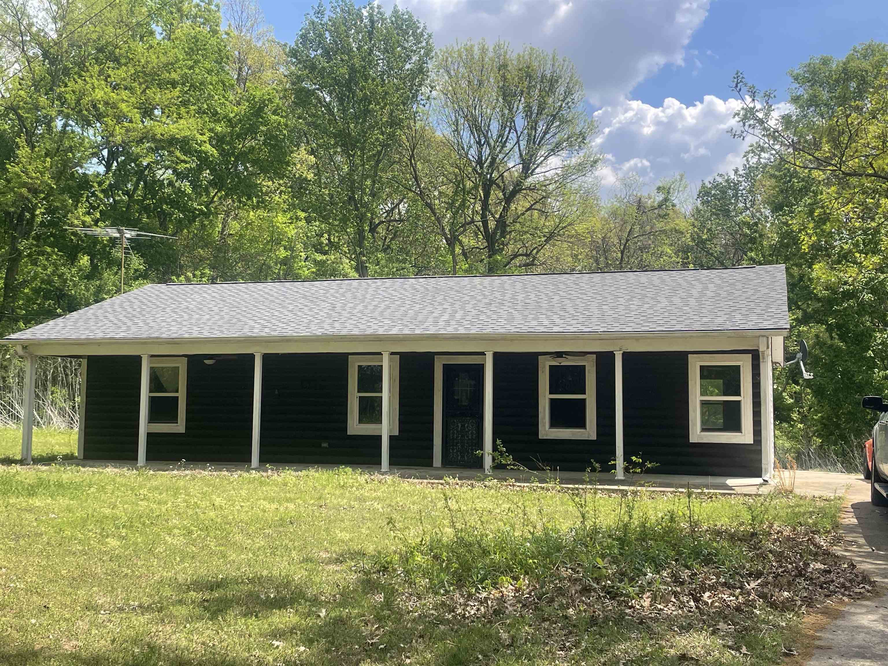 2349 Snyder Bluff Road Ripley, TN 38063 - Photo 1 of 21 View of front of home with roof with shingles, covered porch, and a front yard