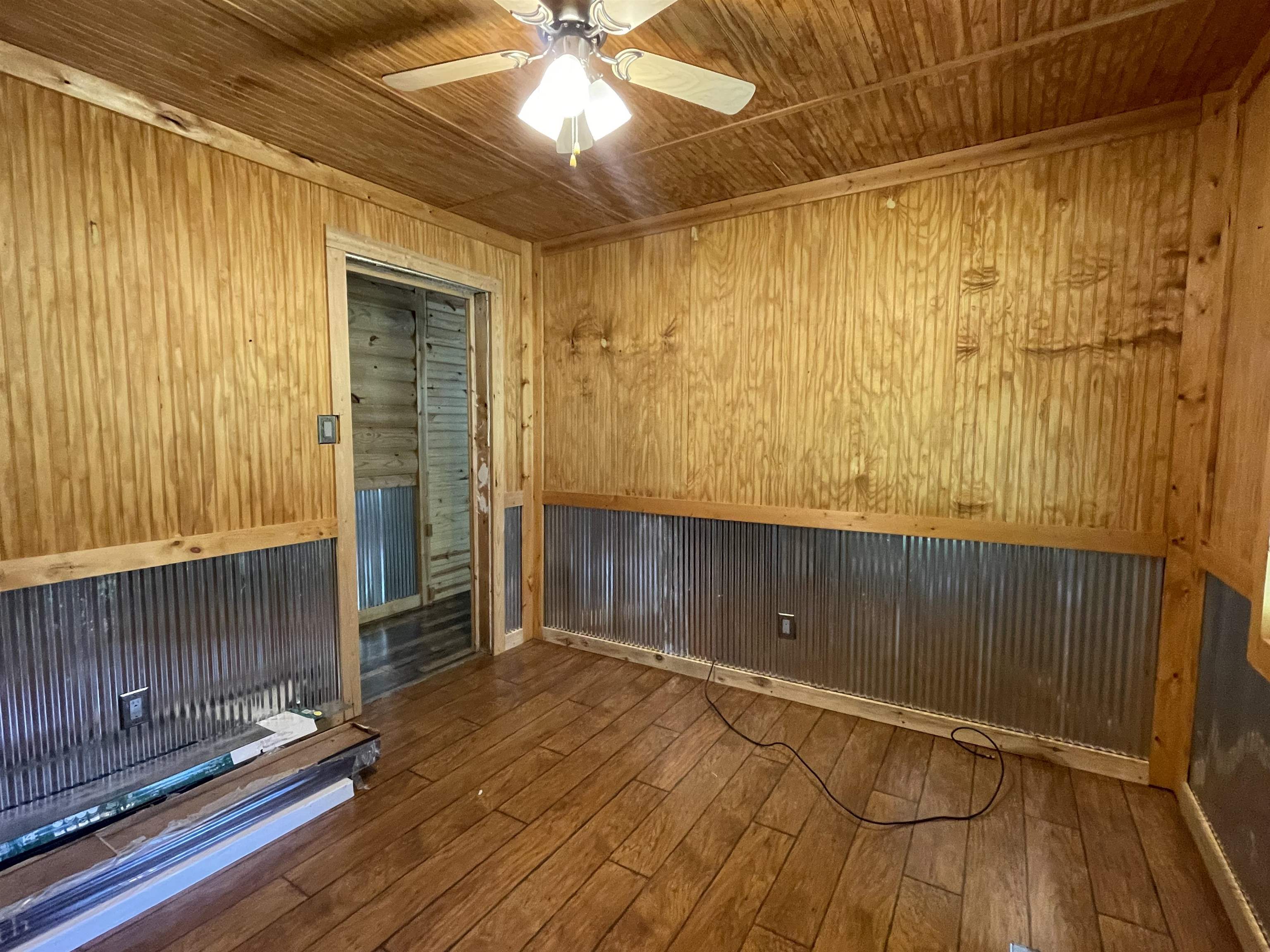 2349 Snyder Bluff Road Ripley, TN 38063 - Photo 16 of 21 Unfurnished room with dark wood-style flooring, wooden walls, ceiling fan, and wood ceiling