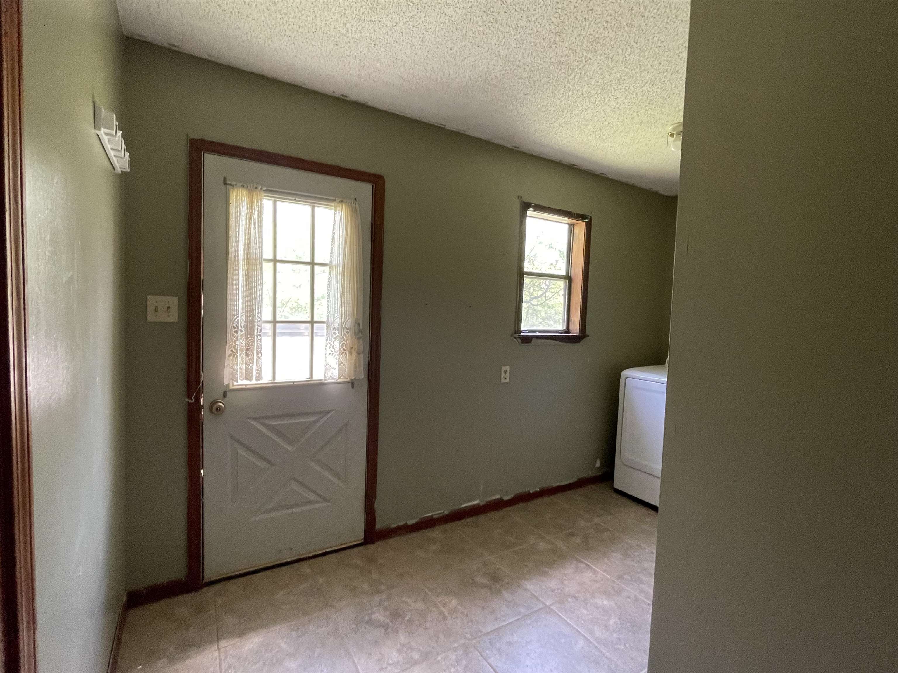 2349 Snyder Bluff Road Ripley, TN 38063 - Photo 19 of 21 Laundry room with a textured ceiling and washer / dryer