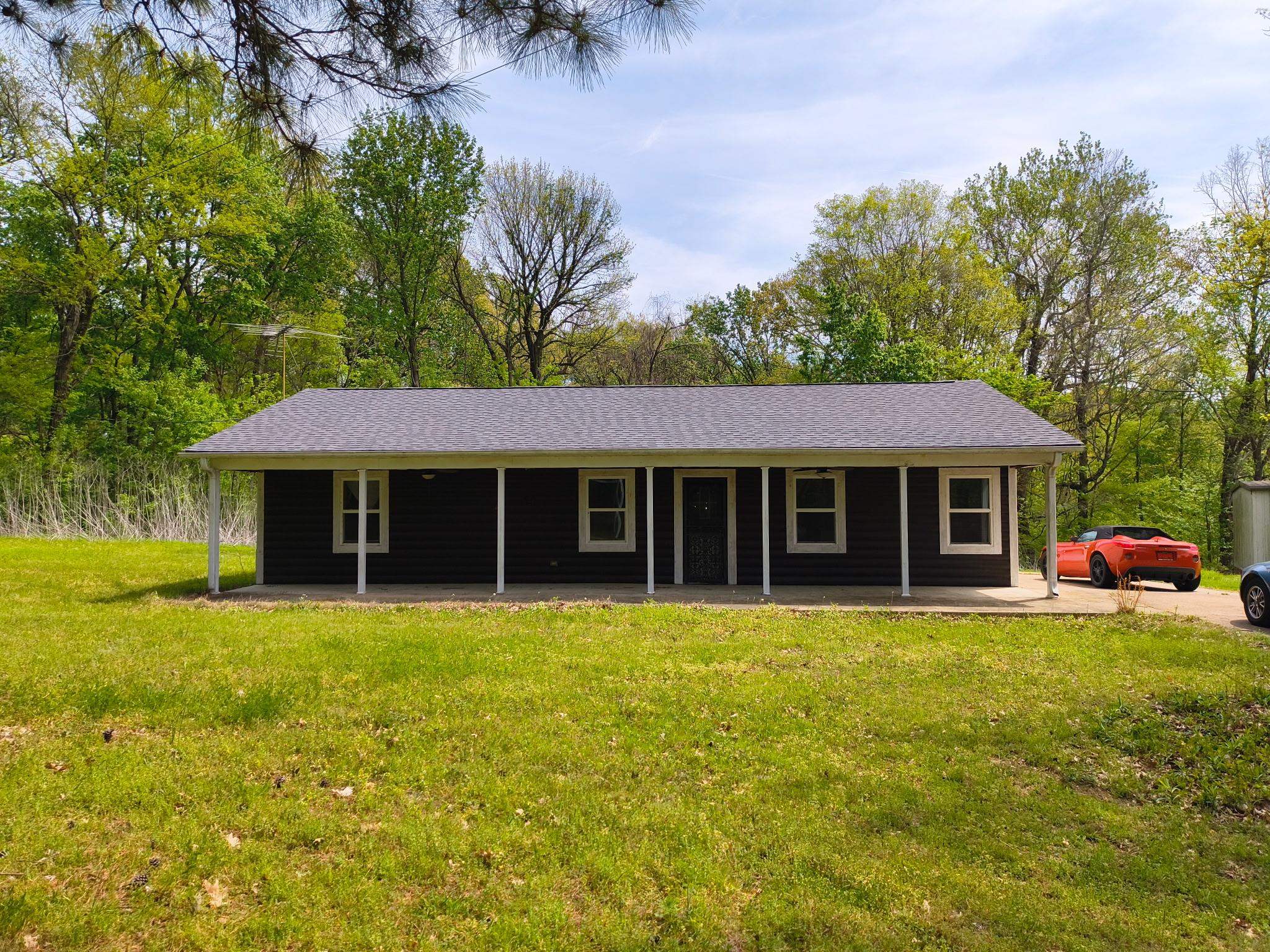 2349 Snyder Bluff Road Ripley, TN 38063 - Photo 2 of 21 View of front of house with a front yard and roof with shingles