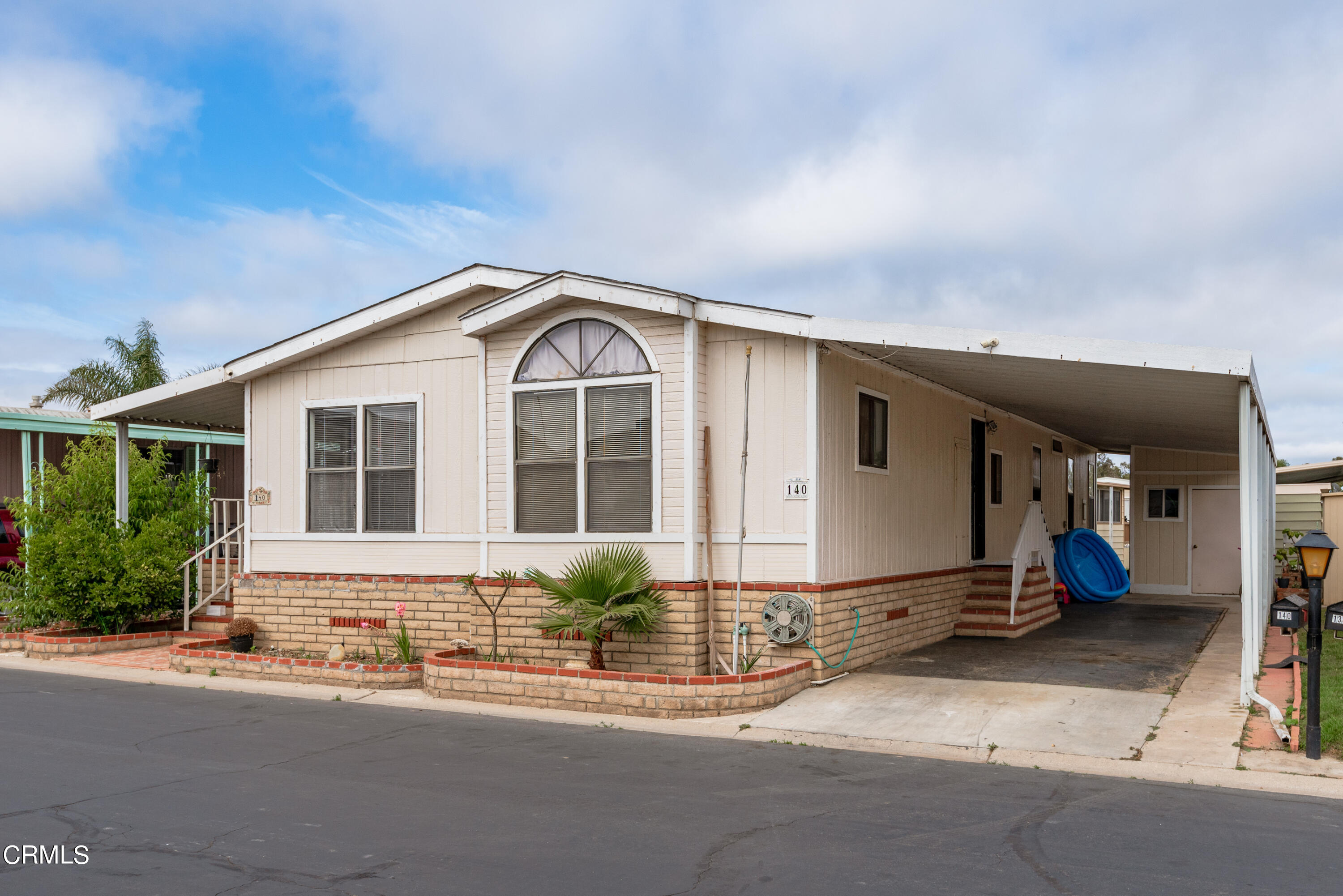 140 Rainbow Drive, Unit 162 Oxnard, CA 93033 - Photo 2 of 19 a front view of a house with a yard