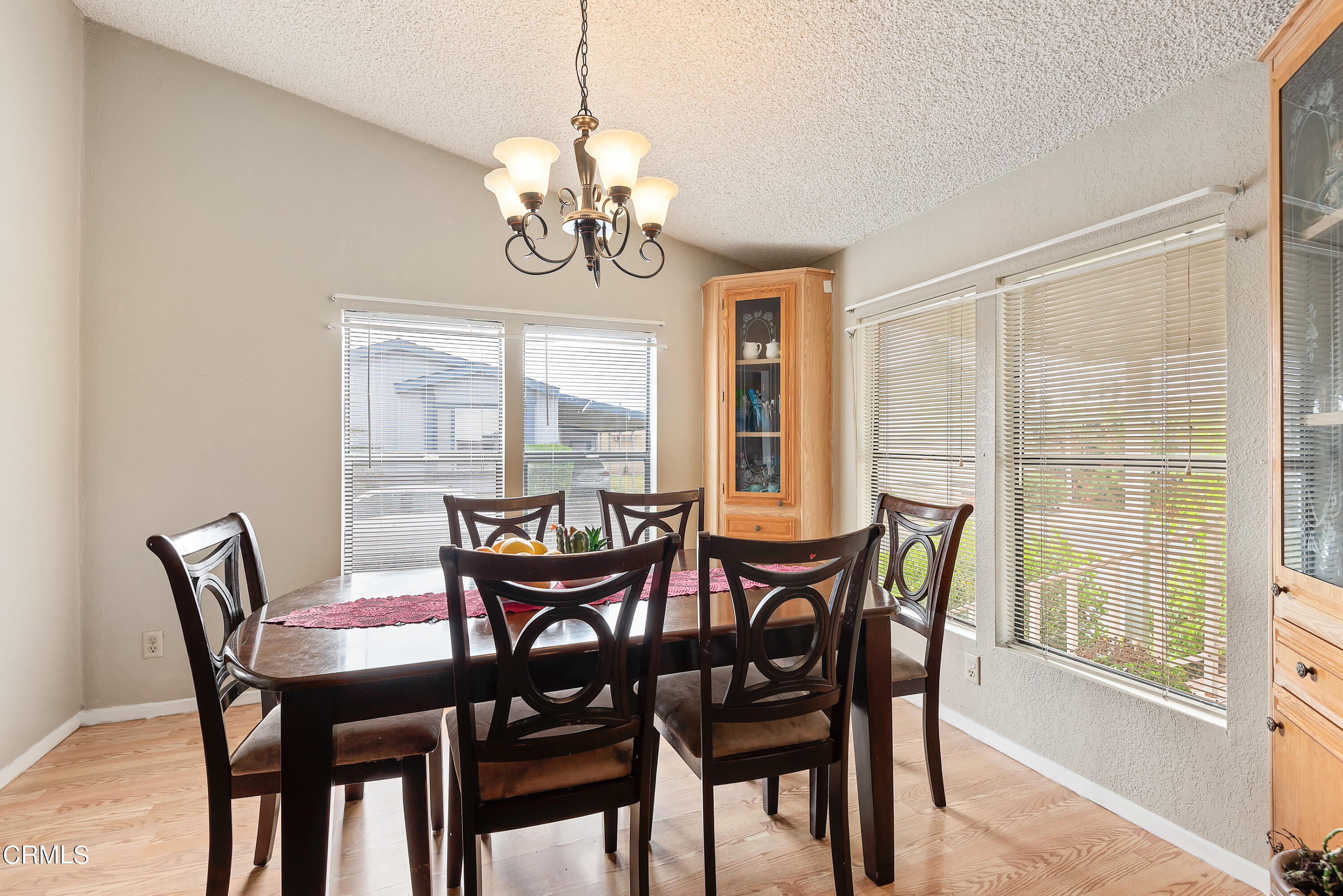 140 Rainbow Drive, Unit 162 Oxnard, CA 93033 - Photo 6 of 19 a view of a dining room with furniture wooden floor and chandelier
