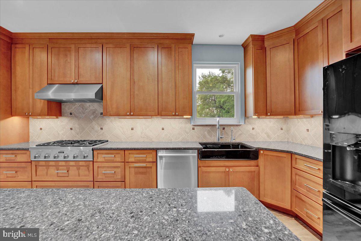 550 Betcher Road Trappe, PA 19426 - Photo 16 of 71 a kitchen with stainless steel appliances granite countertop a stove a sink dishwasher and a microwave oven with cabinets