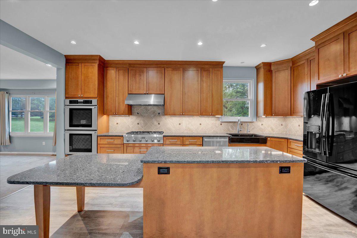 550 Betcher Road Trappe, PA 19426 - Photo 17 of 71 a kitchen with granite countertop a sink a counter top space appliances and cabinets