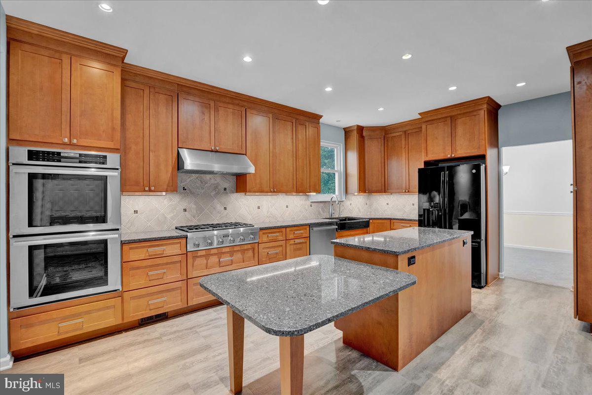 550 Betcher Road Trappe, PA 19426 - Photo 18 of 71 a kitchen with stainless steel appliances granite countertop a stove refrigerator sink and microwave