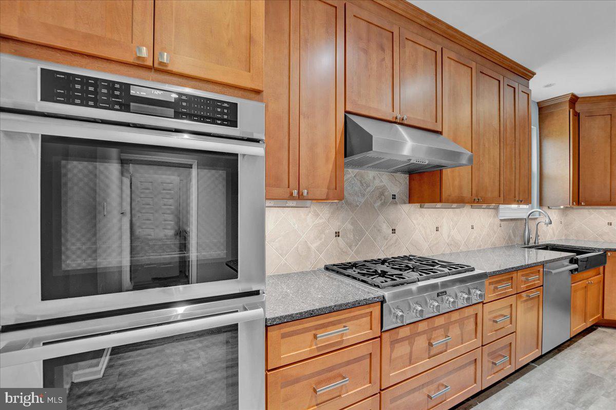 550 Betcher Road Trappe, PA 19426 - Photo 20 of 71 a kitchen with granite countertop cabinets stainless steel appliances and a counter space