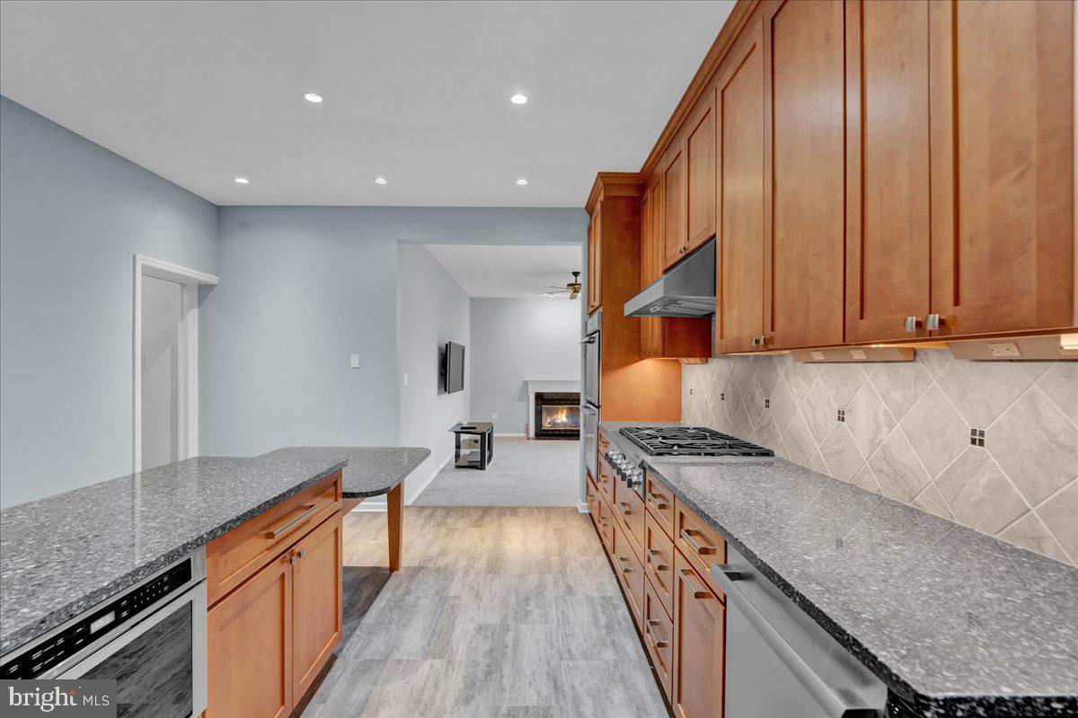 550 Betcher Road Trappe, PA 19426 - Photo 21 of 71 a kitchen with stainless steel appliances granite countertop a stove a sink and a refrigerator