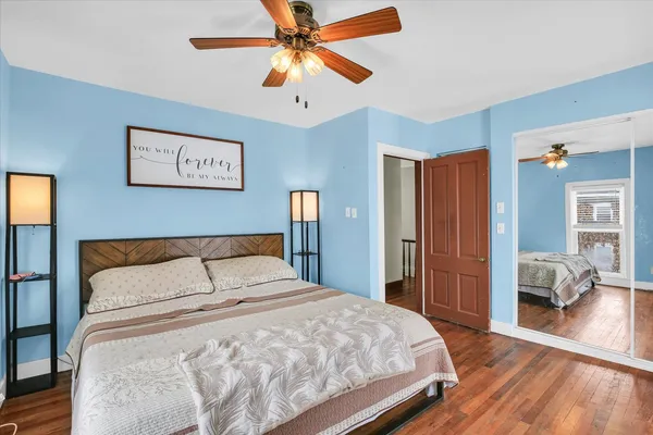 a bedroom with a large bed and a chandelier