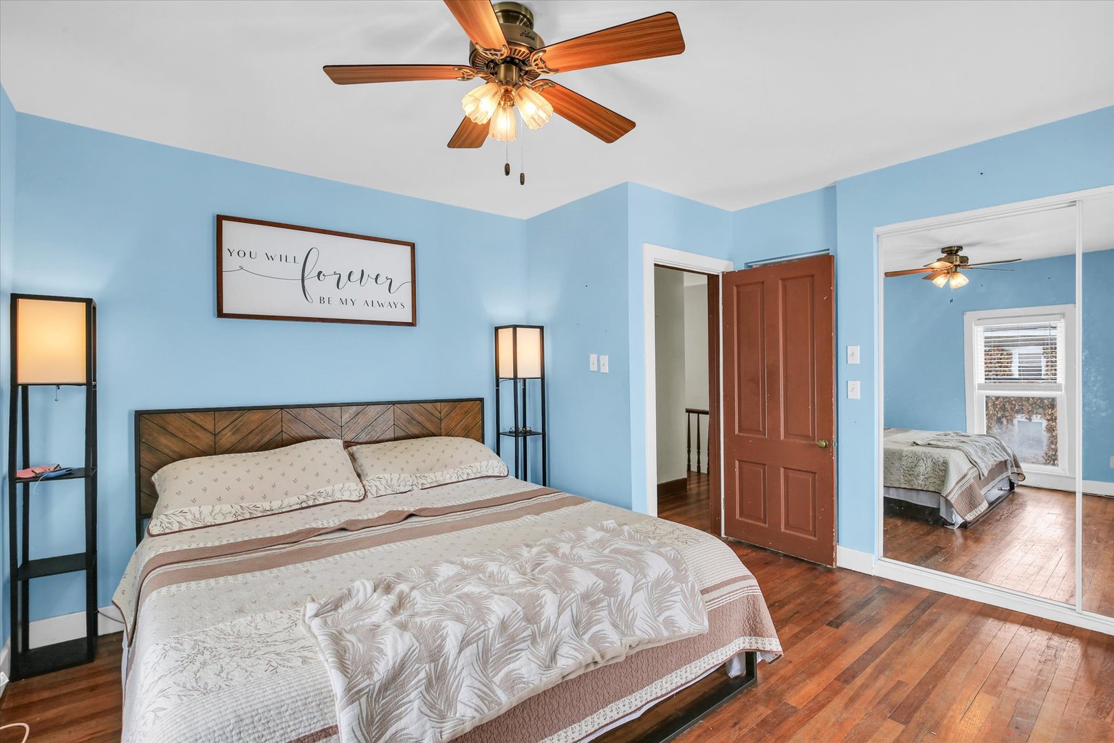 110 East Barker Street Tuscola, IL 61953 - Photo 17 of 32 a bedroom with a large bed and a chandelier