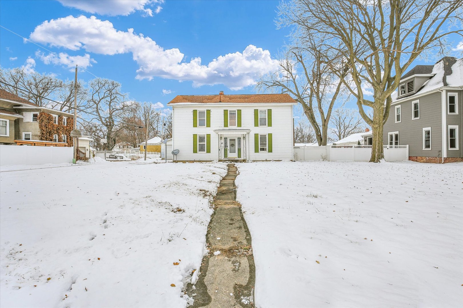 110 East Barker Street Tuscola, IL 61953 - Photo 2 of 32 a view of white house with a snow in the yard