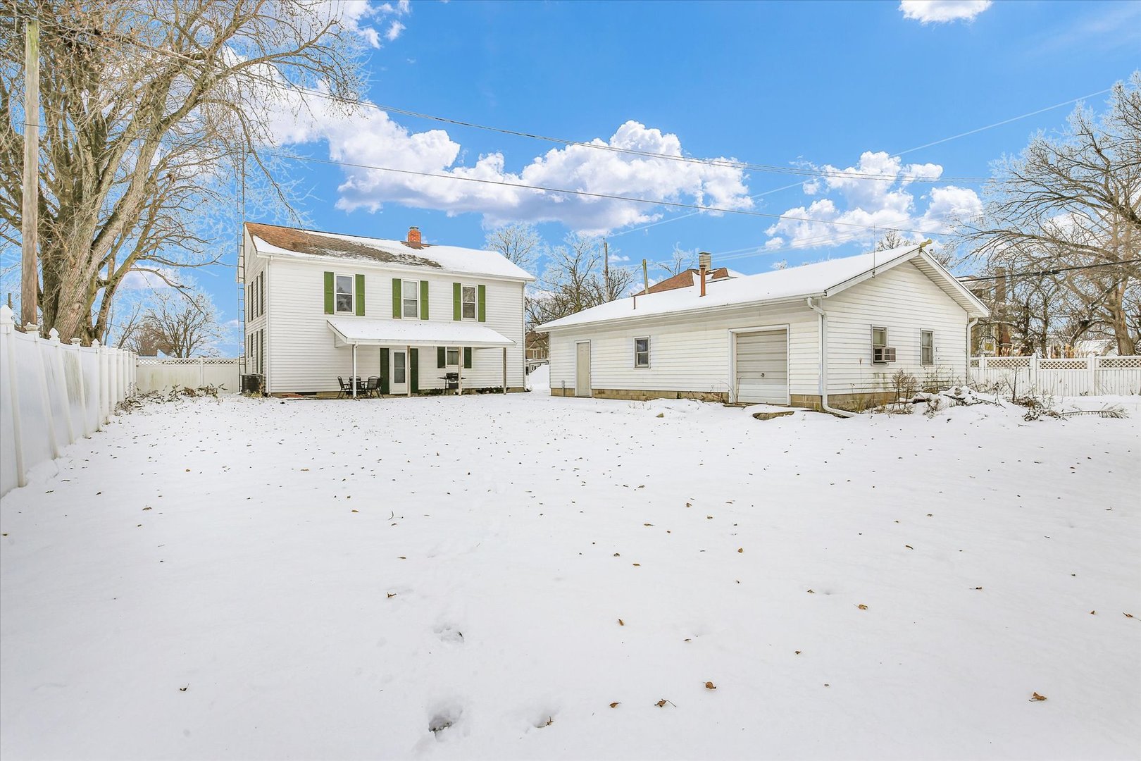 110 East Barker Street Tuscola, IL 61953 - Photo 31 of 32 a view of white house with a snow on the road
