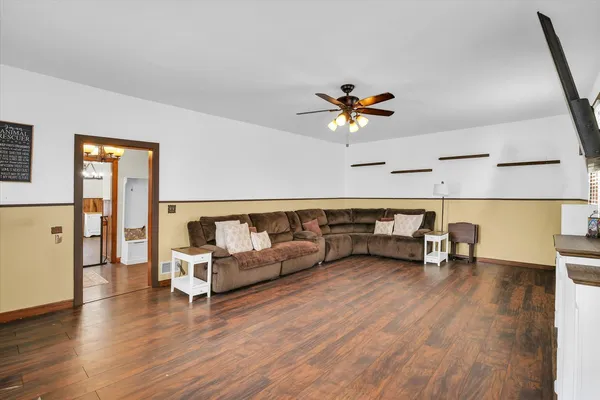 a living room with furniture and a wooden floor
