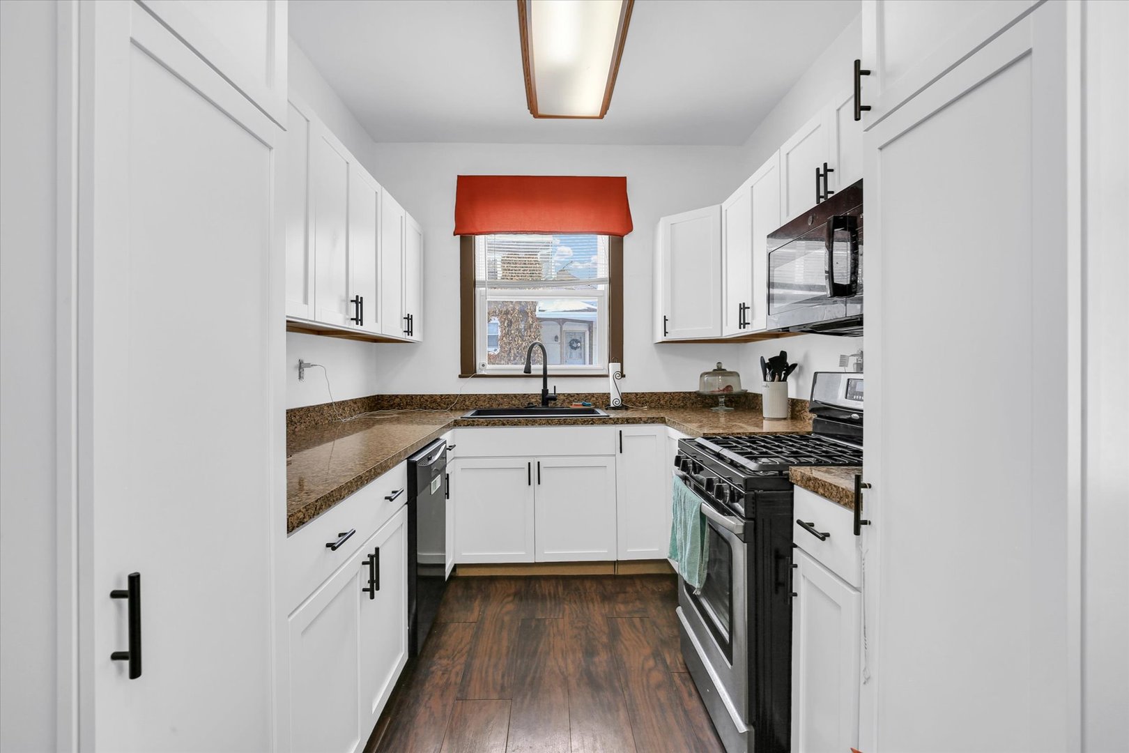 110 East Barker Street Tuscola, IL 61953 - Photo 10 of 32 a kitchen with stainless steel appliances granite countertop a stove a sink and a microwave