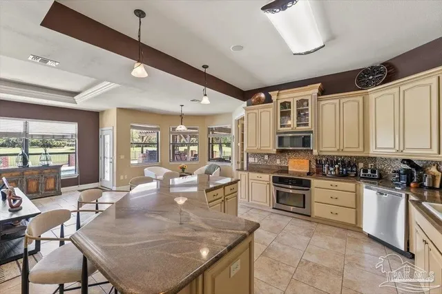 a kitchen with sink refrigerator dining table and chairs
