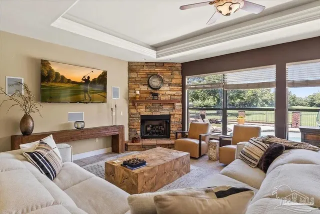 a living room with furniture a fireplace and a flat screen tv