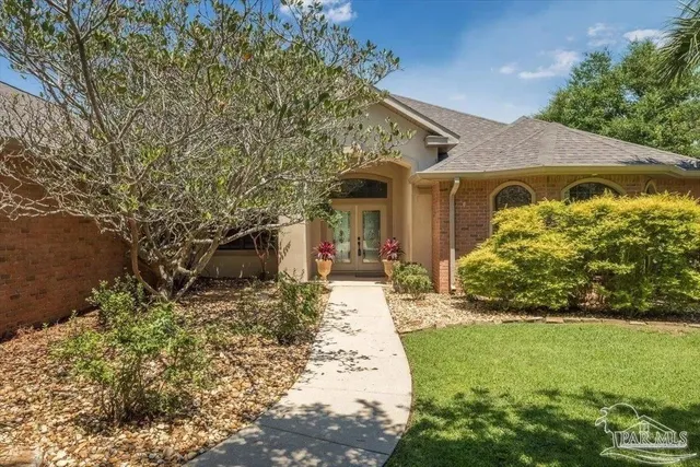 a front view of a house with garden