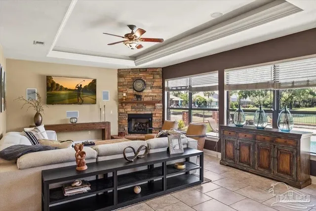 a living room with furniture a flat screen tv and a fireplace