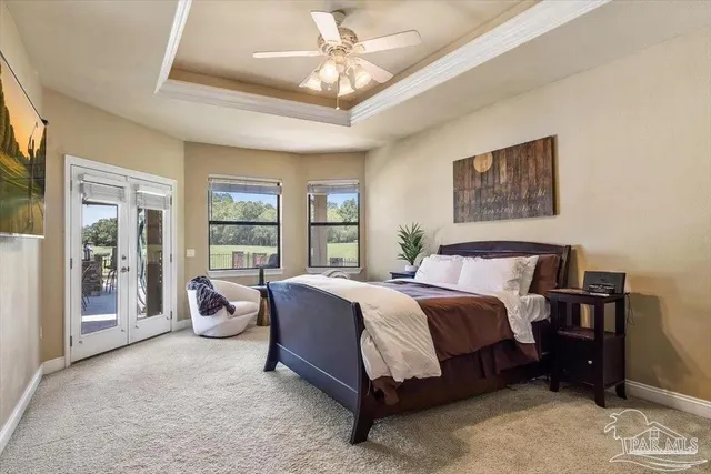 a spacious bedroom with a bed and large window