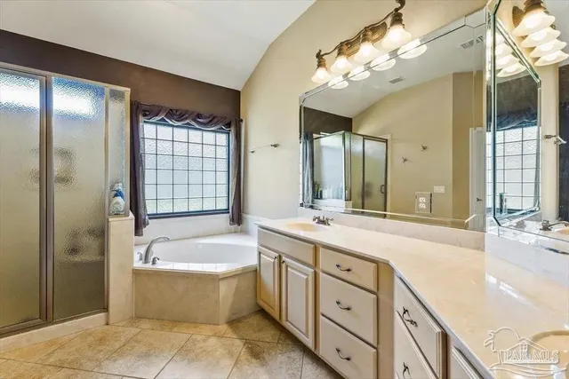 a spacious bathroom with a double vanity sink a large mirror and a bathtub