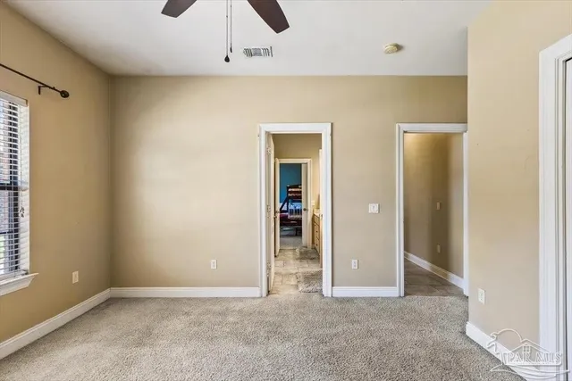 a en suite bathroom with a double vanity sink and a mirror