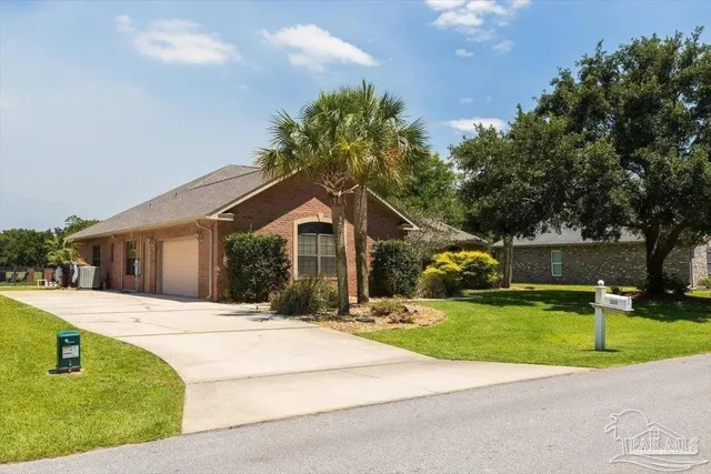 a front view of a house with a yard and trees