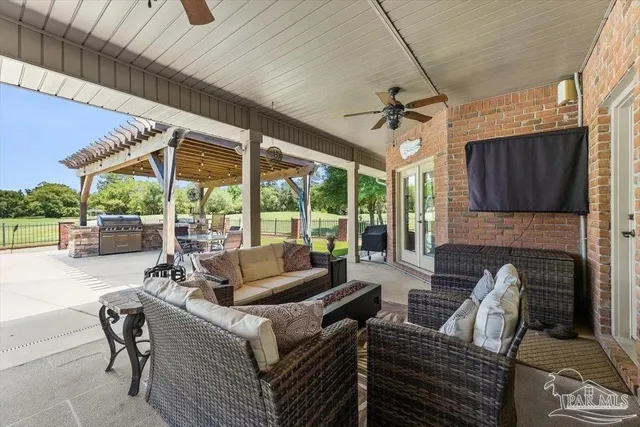 swimming pool view with a seating space and garden view