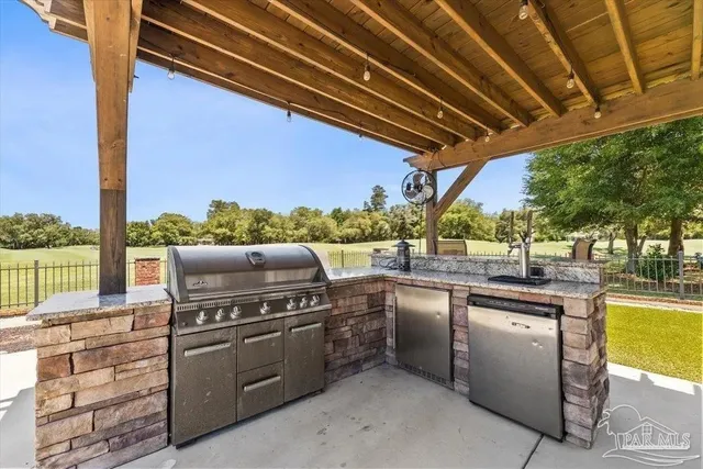 a roof deck with couches and wooden floor