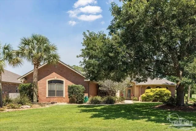 a front view of house with yard and green space
