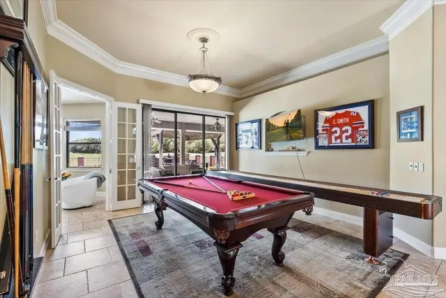 a living room with furniture pool table and a flat screen tv