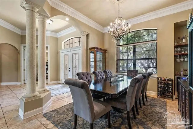 a view of a dining room with furniture and chandelier